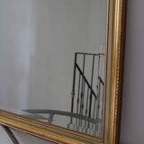 Large beveled mirror in carved wood