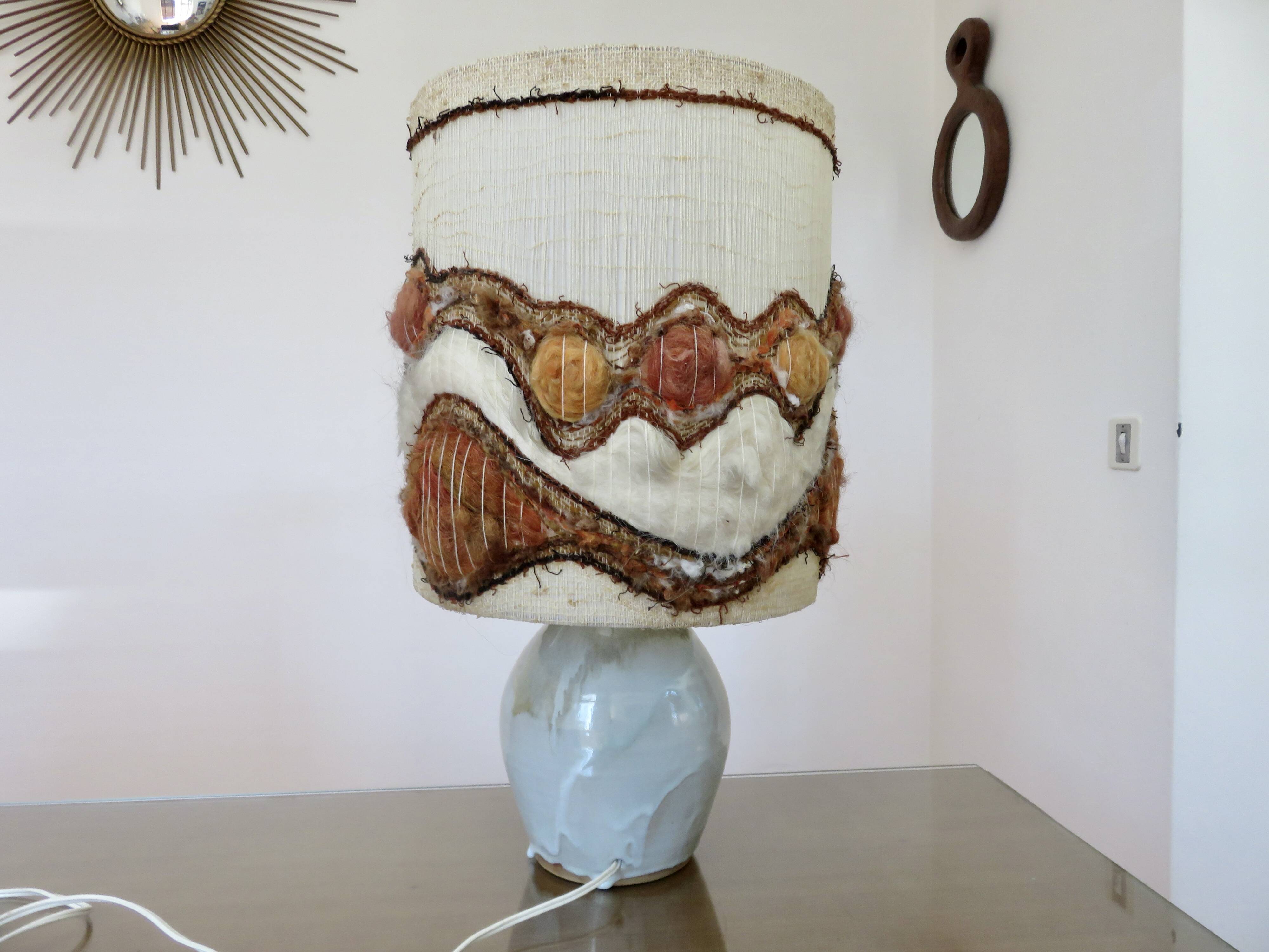 Ceramic lamp with double lighting and openwork design.