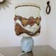 Ceramic lamp with double lighting and openwork design.