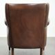 Subtle sheepskin wingback armchair with a deep cognac colour