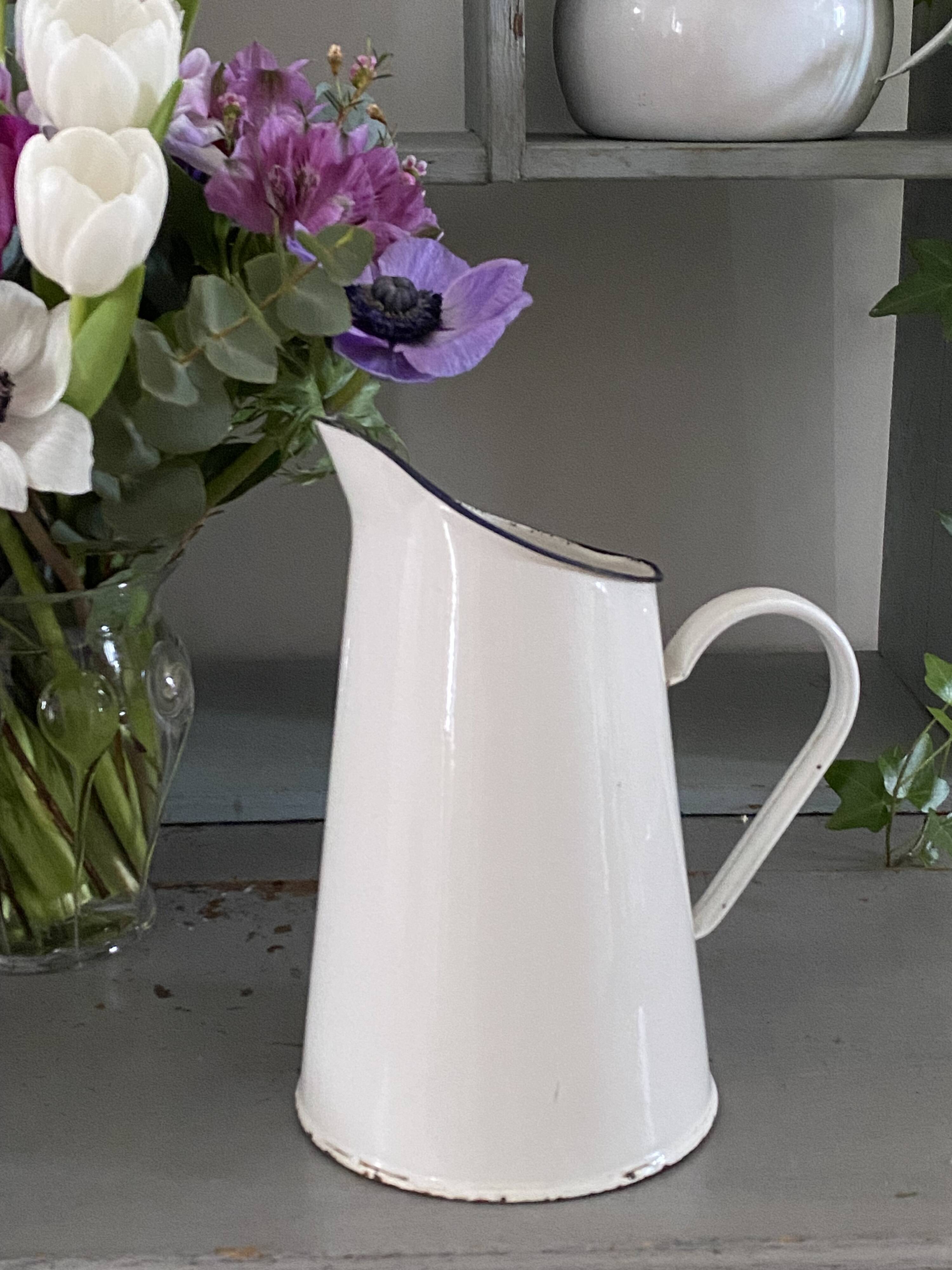 Old white enameled pitcher