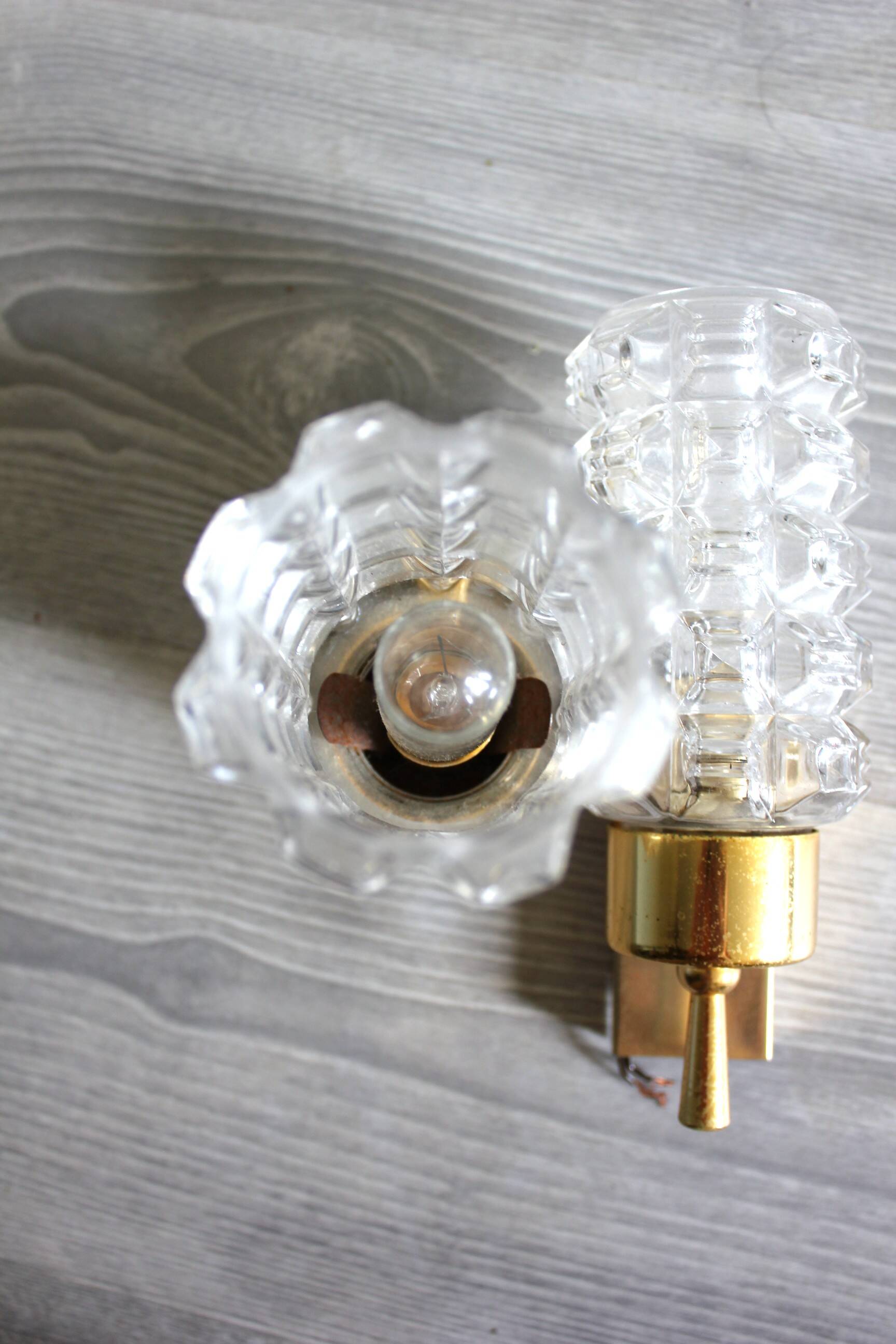 Pair of vintage wall sconces in gilded brass with moulded glass.