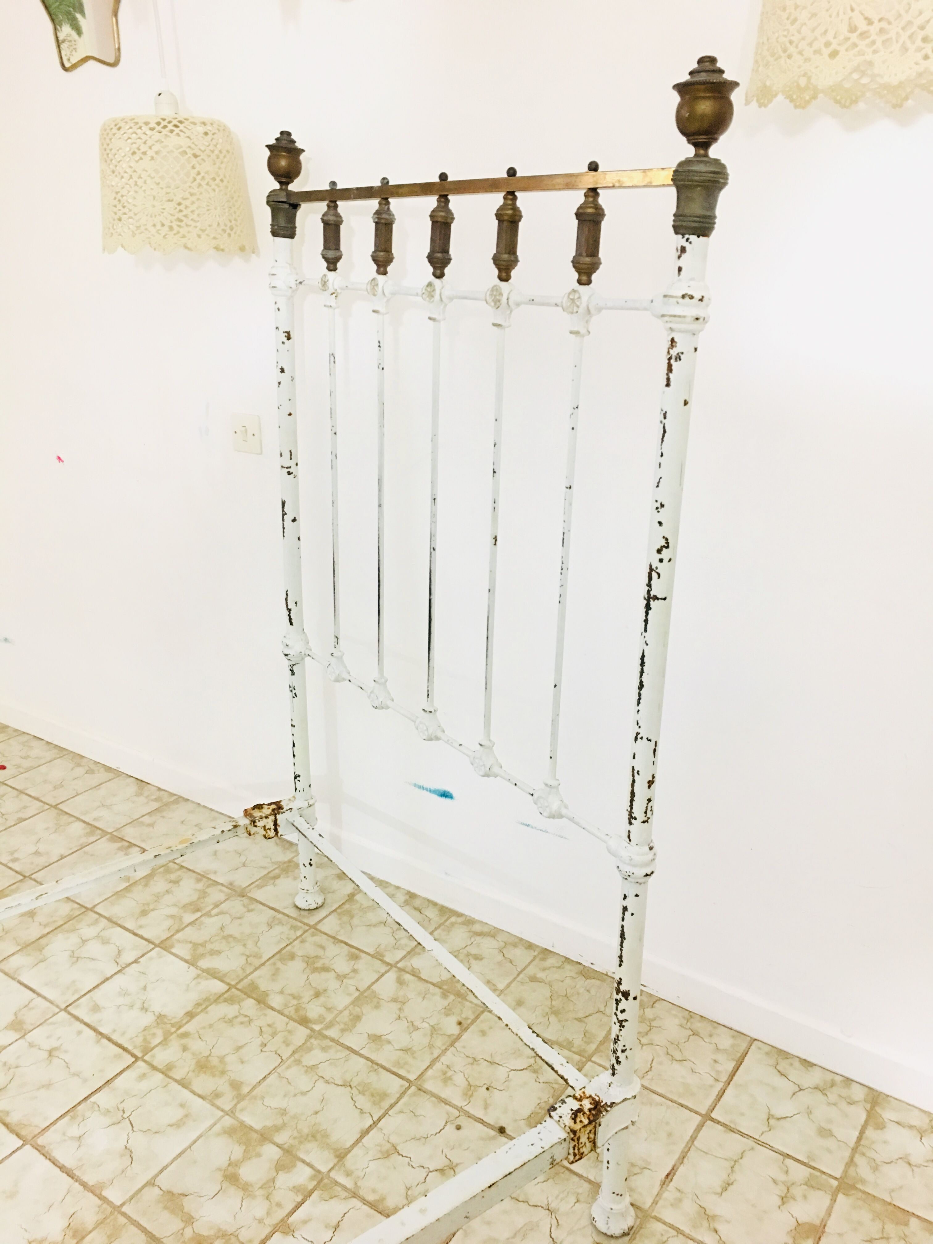 Old white metal and brass bed