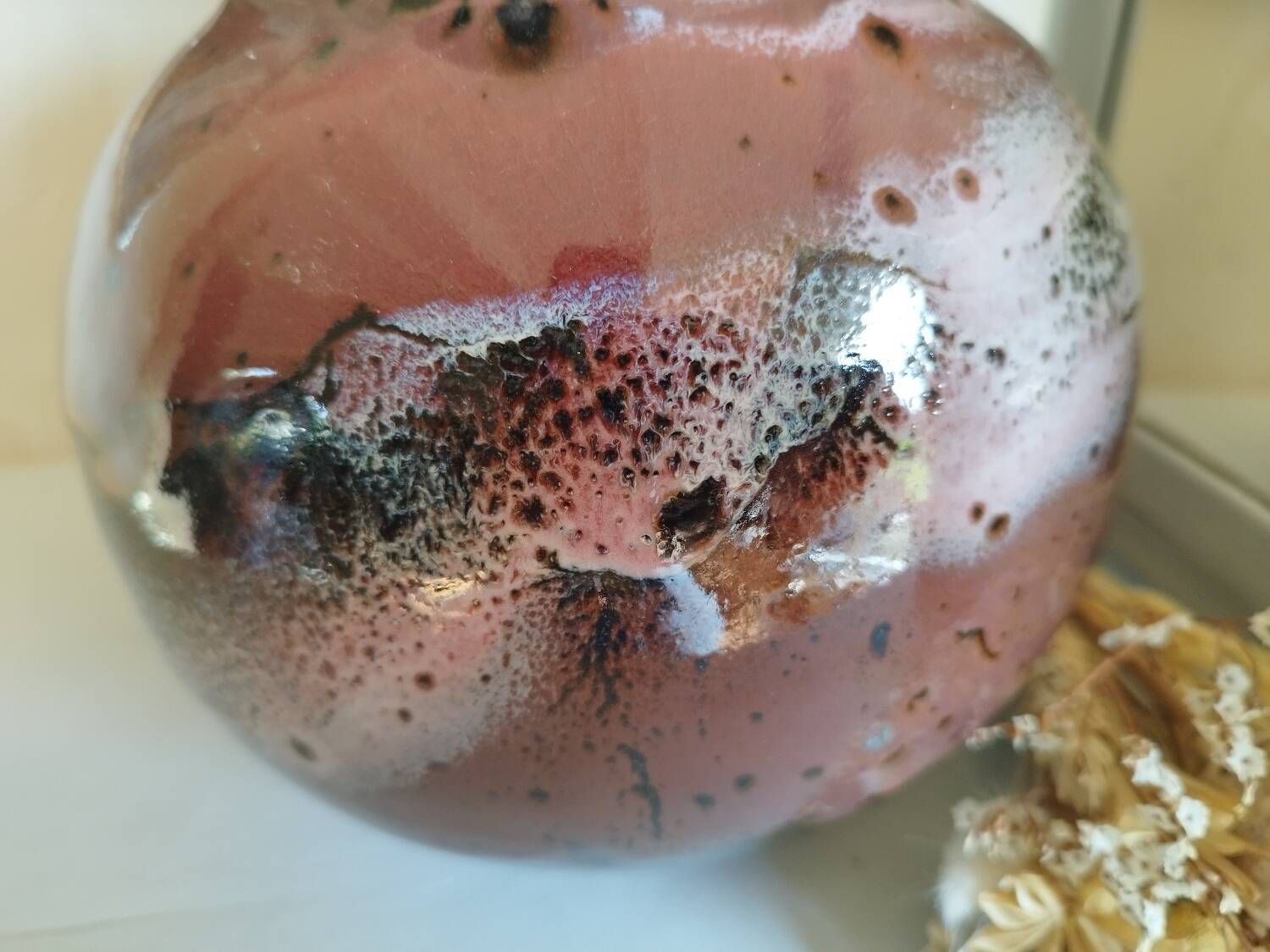 Stoneware pitcher by Matthieu Liévois in shades of red