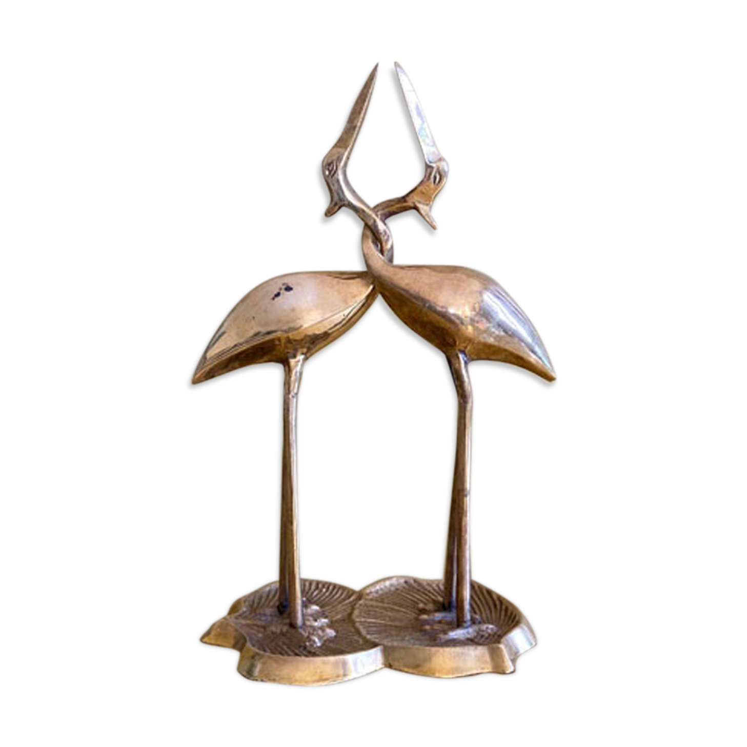Couple of brass intertwined herons