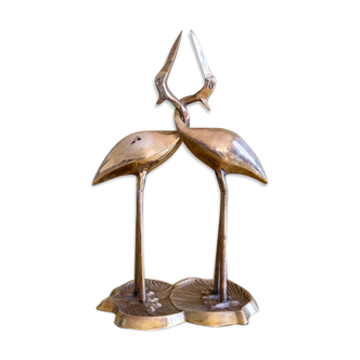 Couple of brass intertwined herons