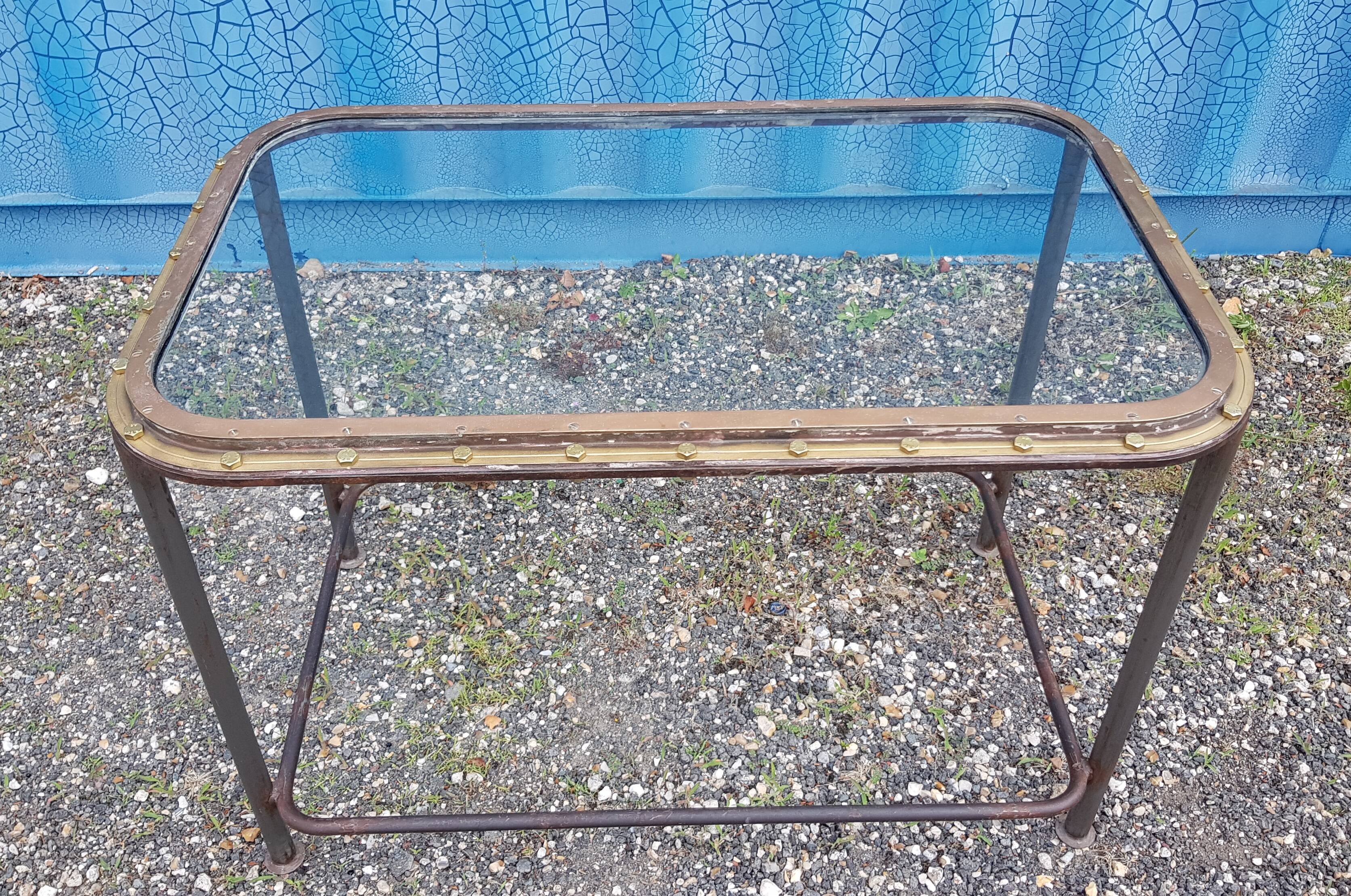 Table with an old ship porthole in brass and a metal base / 110 x 70 x 76 cm