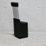 Brutalist chair, black-stained raw wood, steel. Work from the 1970s