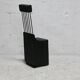 Brutalist chair, black-stained raw wood, steel. Work from the 1970s