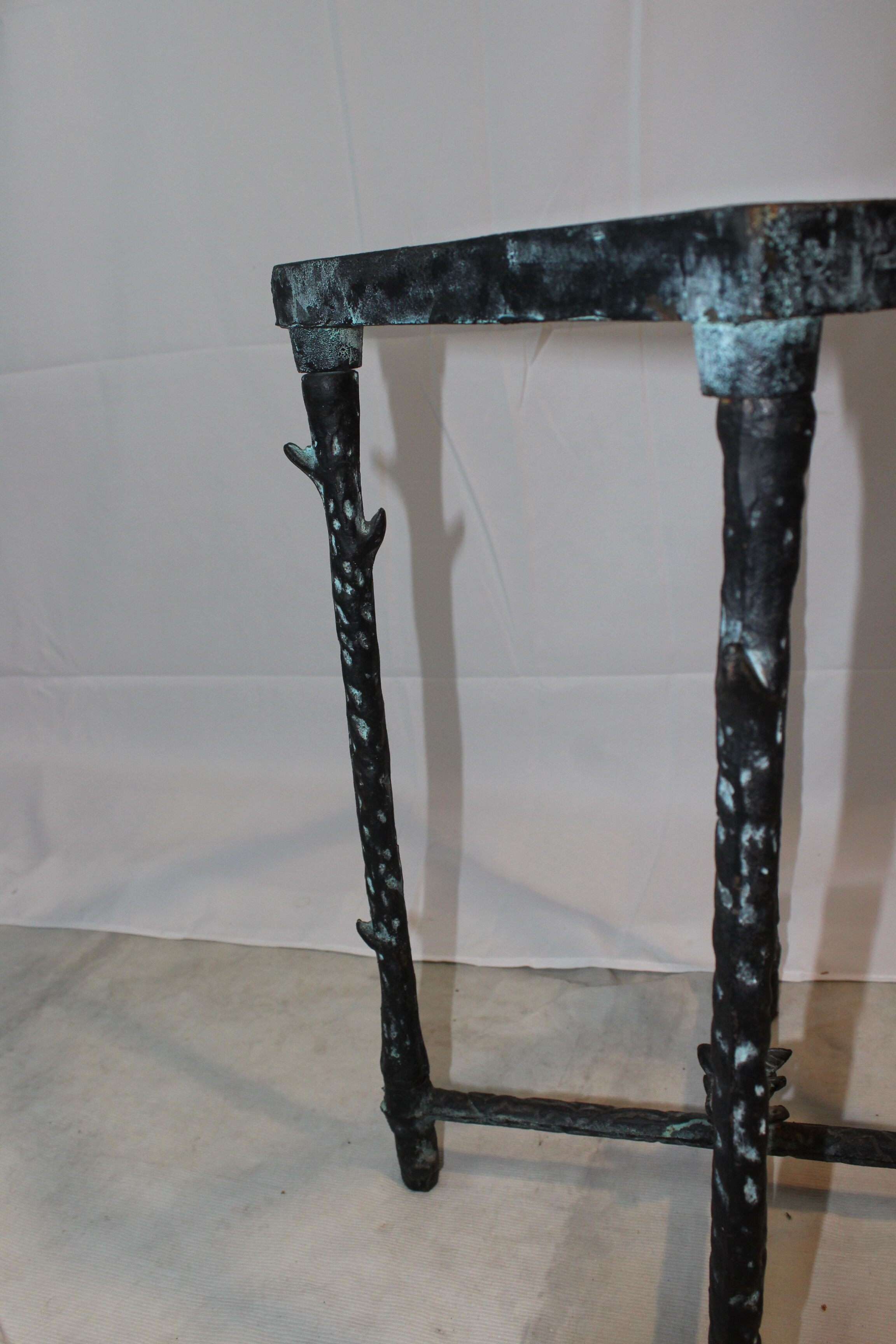 Giacometti style cast iron table, glass table