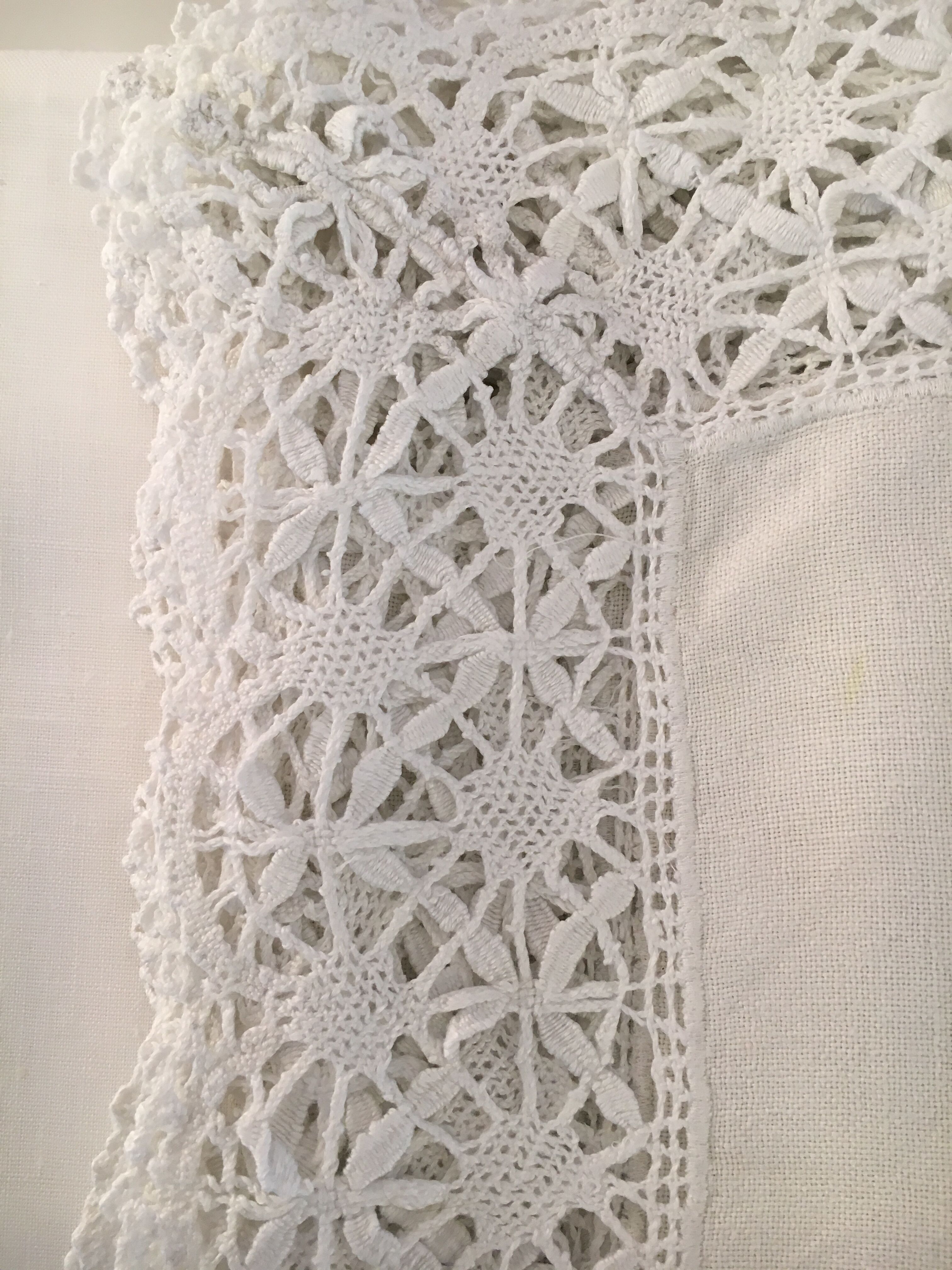 Old embroidered white linen and surnappe tablecloth