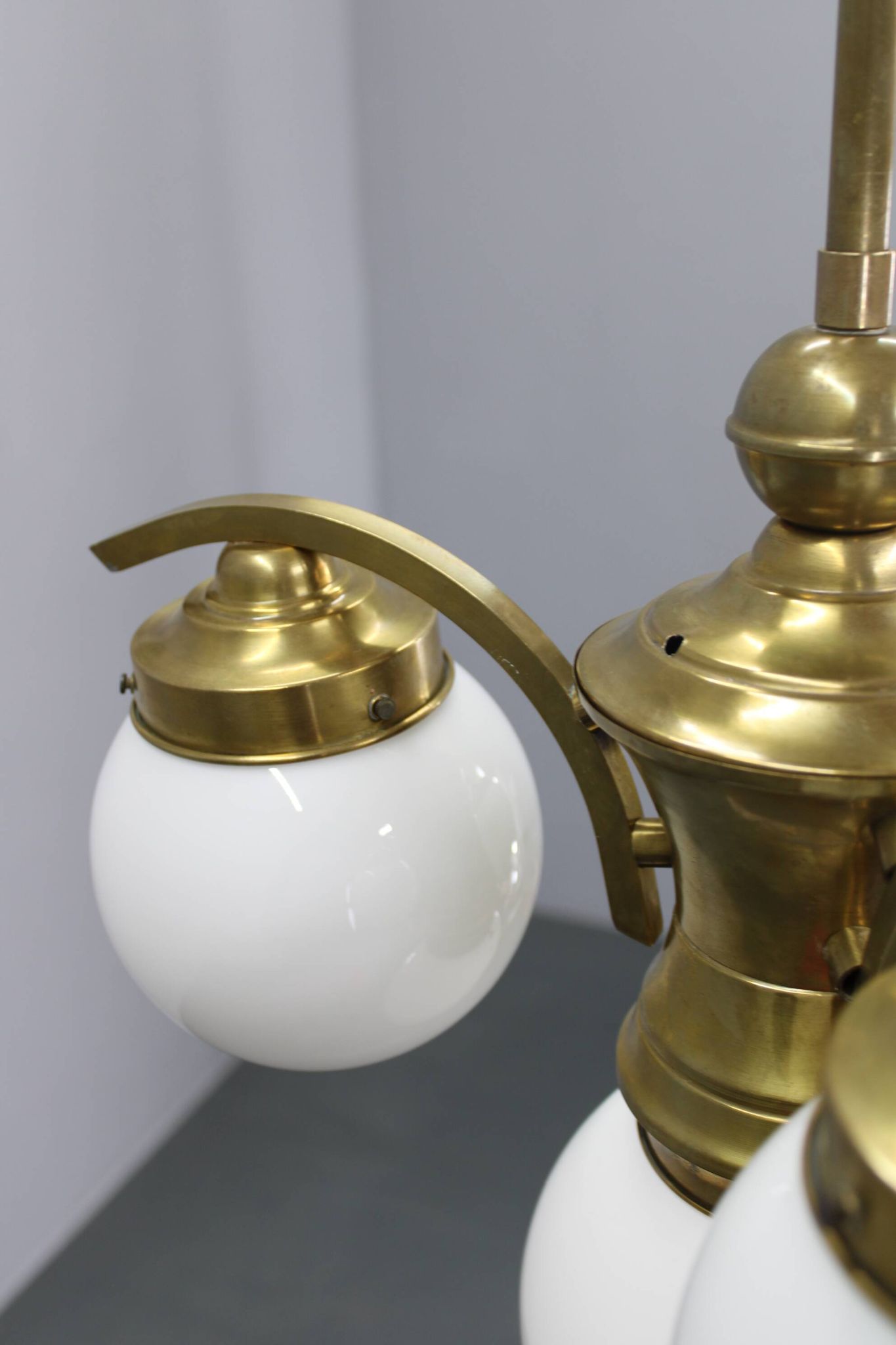 1930s Czechoslovak Art Deco brass chandelier with four opaline glass globes