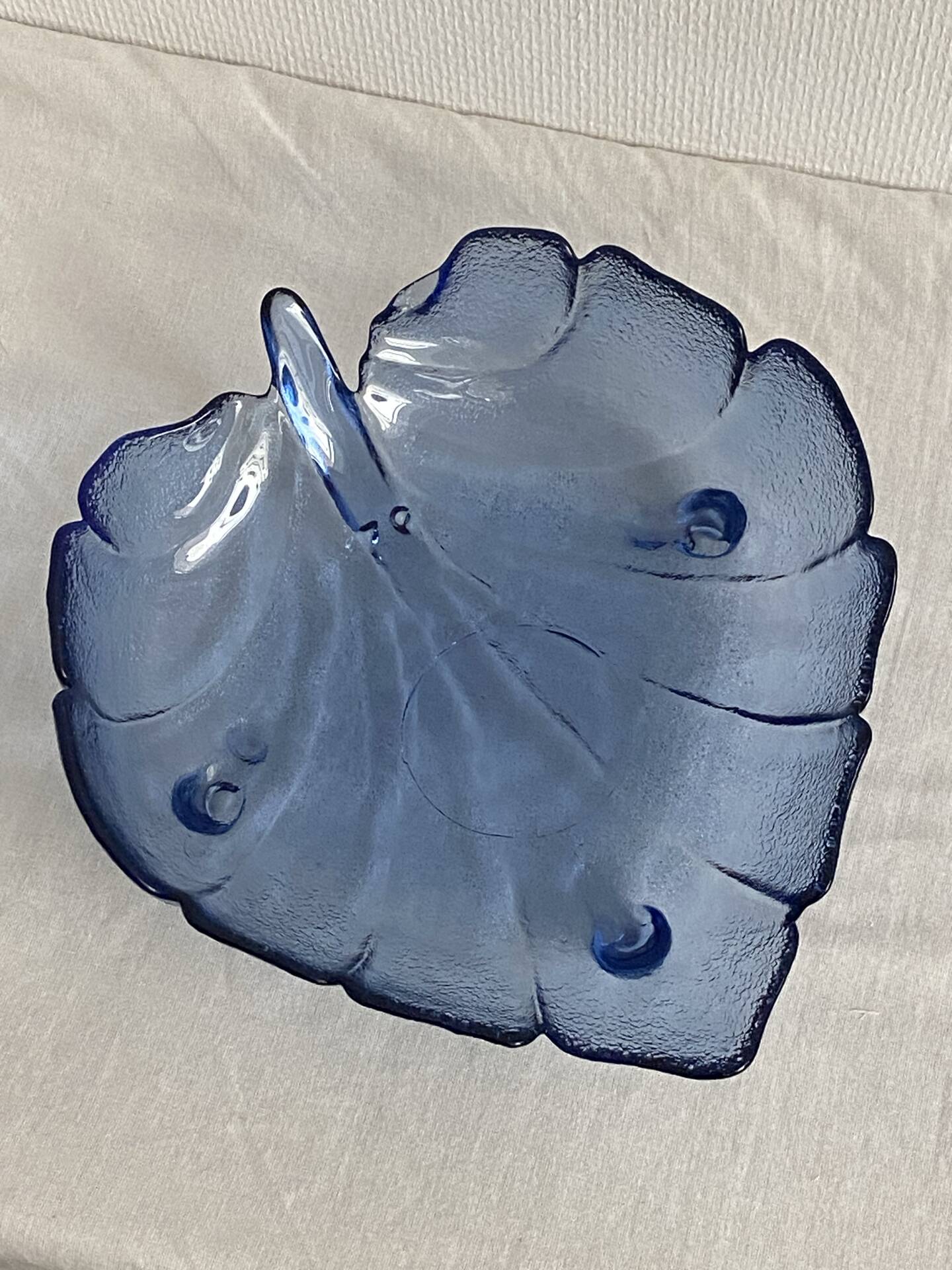 Large leaf-shaped fruit bowl, made of moulded blue glass.