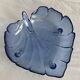 Large leaf-shaped fruit bowl, made of moulded blue glass.