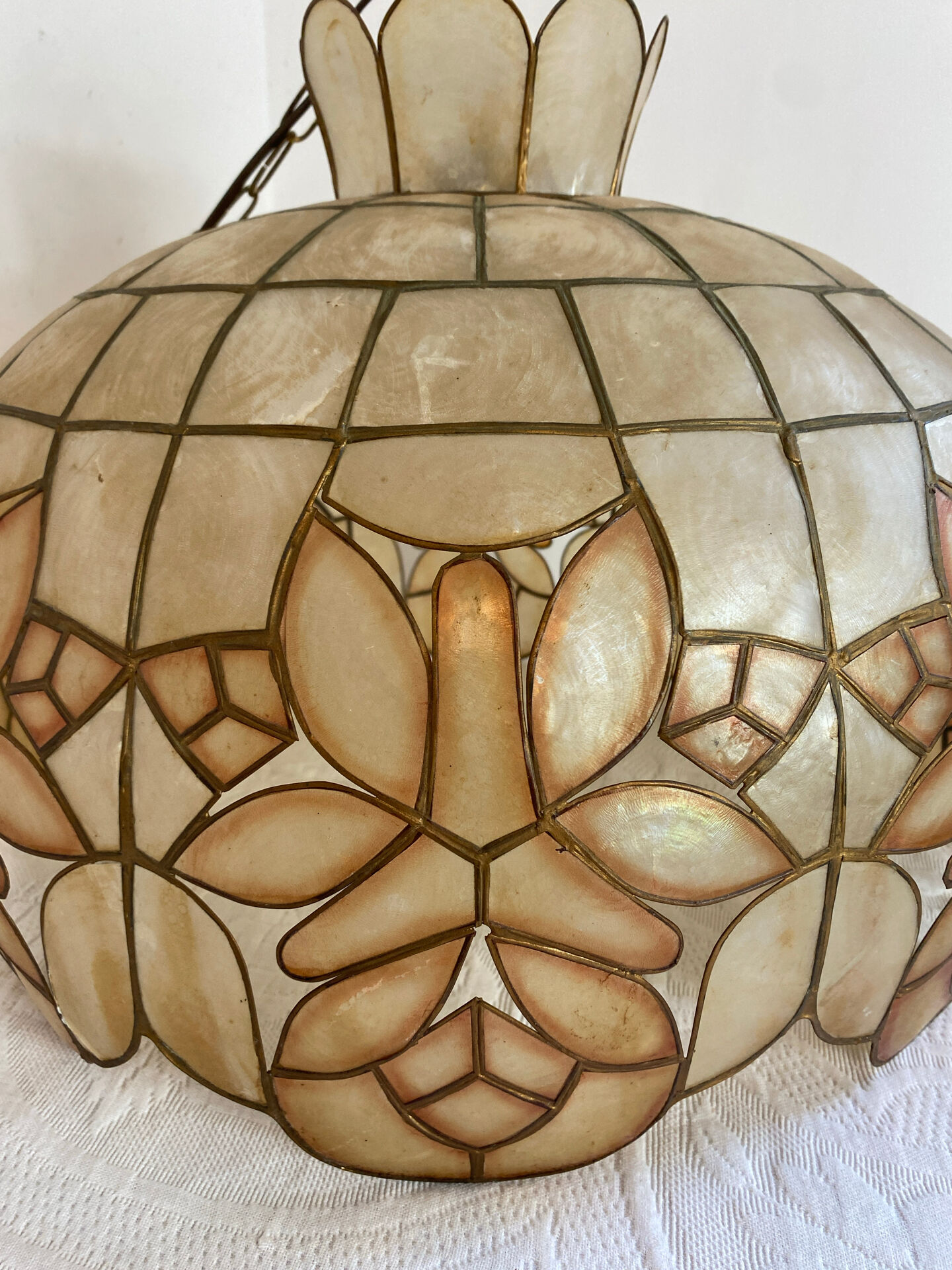 Large mother-of-pearl and brass chandelier with floral decoration.