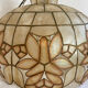 Large mother-of-pearl and brass chandelier with floral decoration.