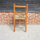 Old wooden high chair for children with straw.