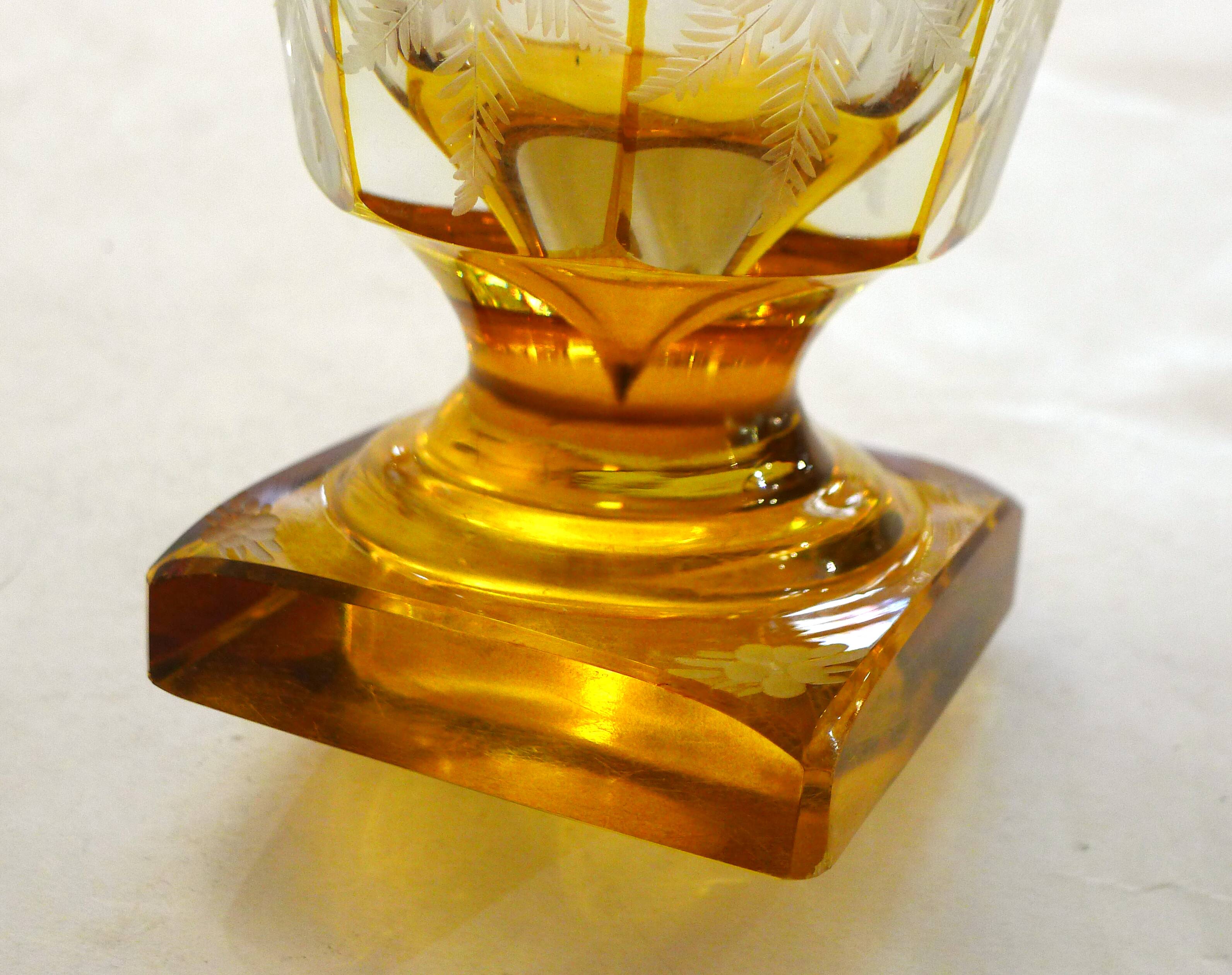 Art Deco vase engraved with flowers, faceted body on a pedestal.