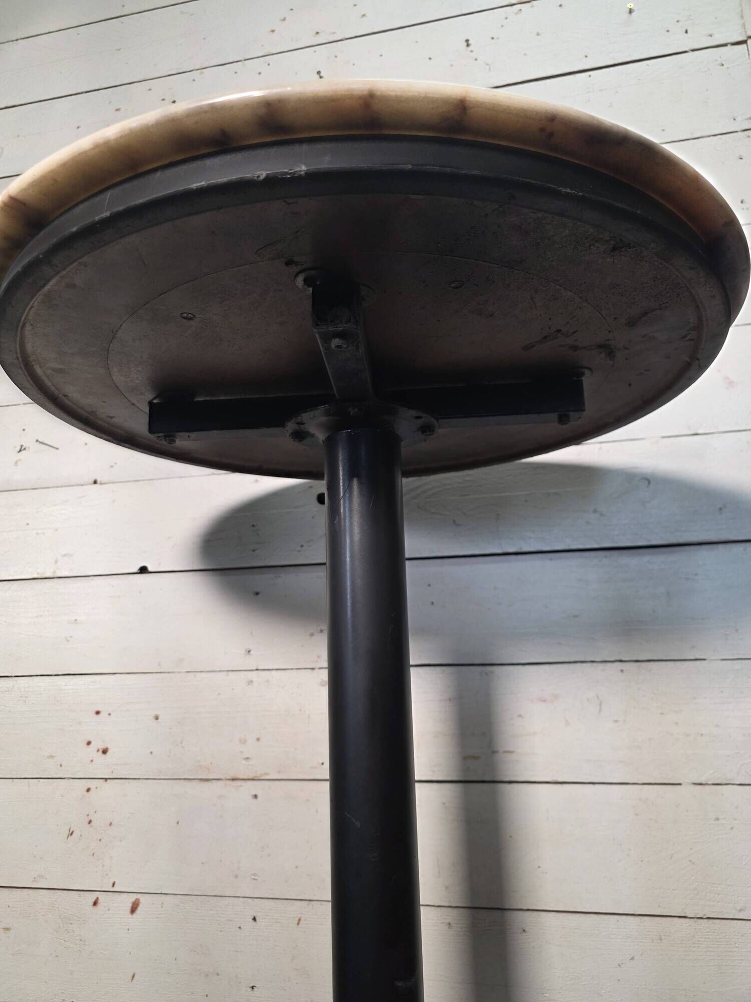 Bistro standing table with marble top and cast iron base.