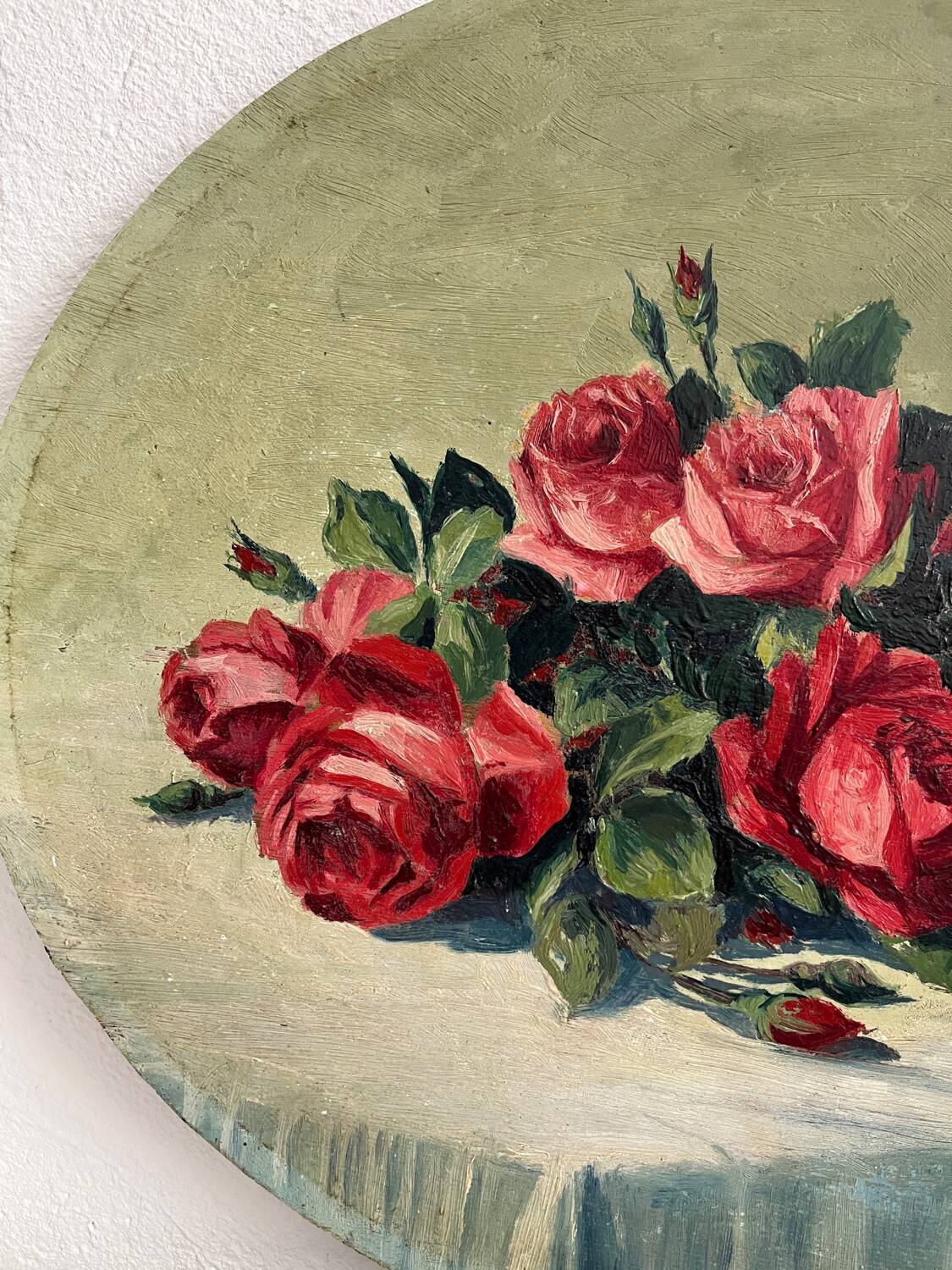 Old oil painting on oval wood with roses thrown from the 30s