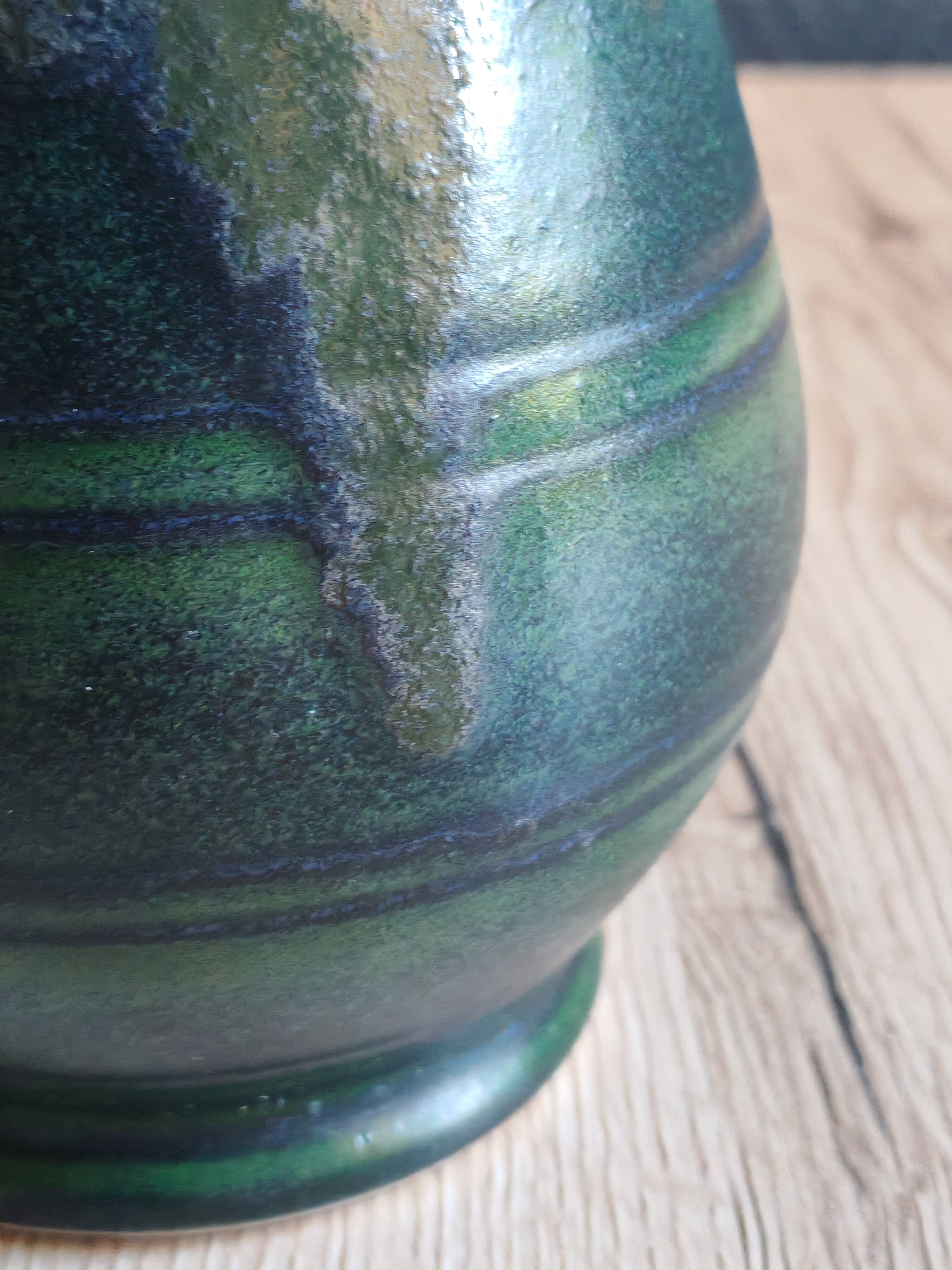 Vintage ceramic pitcher vase in glazed green and blue.