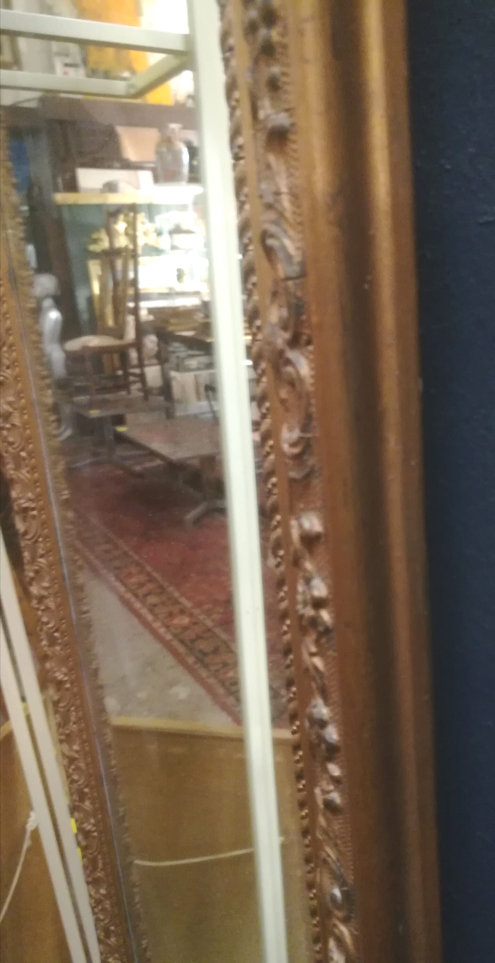 High and narrow mirror in gilded stucco late nineteenth century