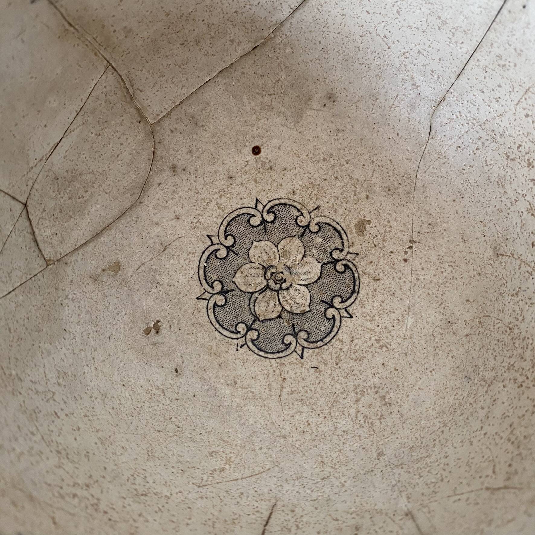 Old bowl made of iron with ceramic seams.