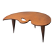 Mid-century coffee table with a palette shape and splayed legs.