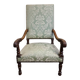 Antique Louis XIV style armchair in moulded wood and damask-style fabric.