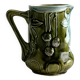 Green slip milk jug with floral patterns.