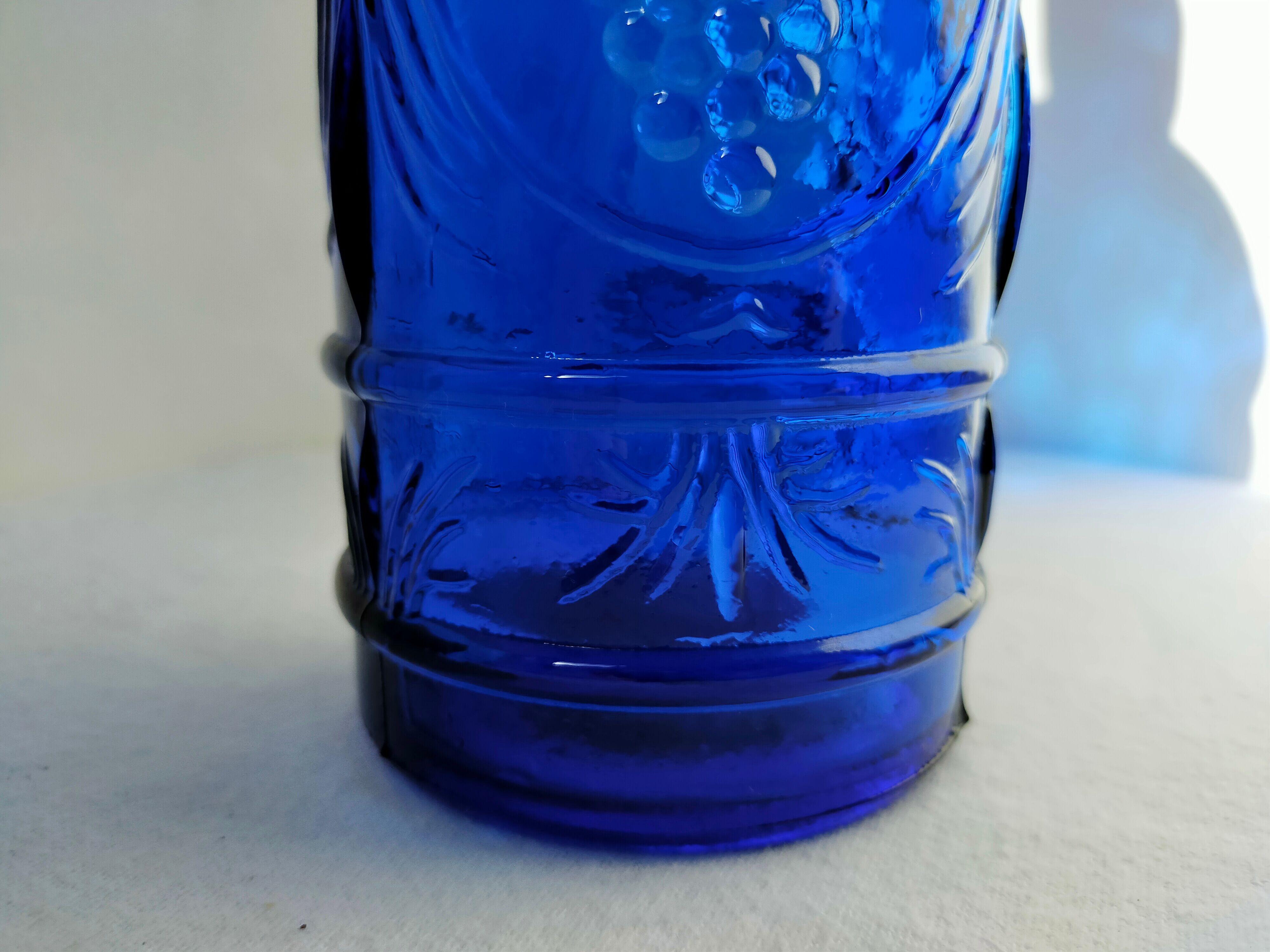 cobalt blue molded glass bottle in relief decoration bunches of grapes