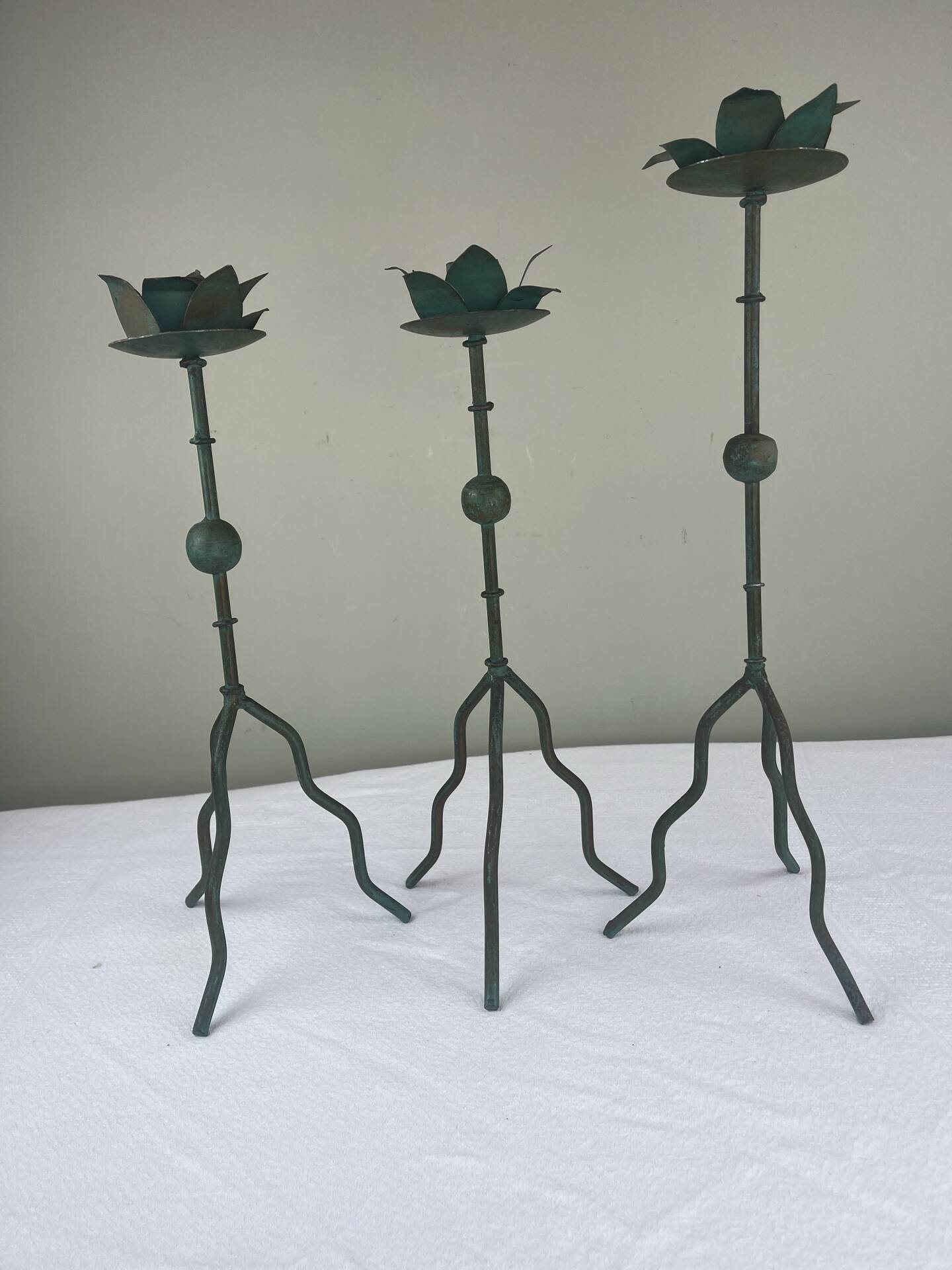 Sculptural candle holder trio