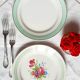 Old mismatched earthenware dinner plates accompanied by a deep dish
