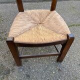 Solid wood chair in dark oak with rush seating, Louis Philippe style.