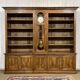 Library in walnut and oak from the early 20th century with its central clock.