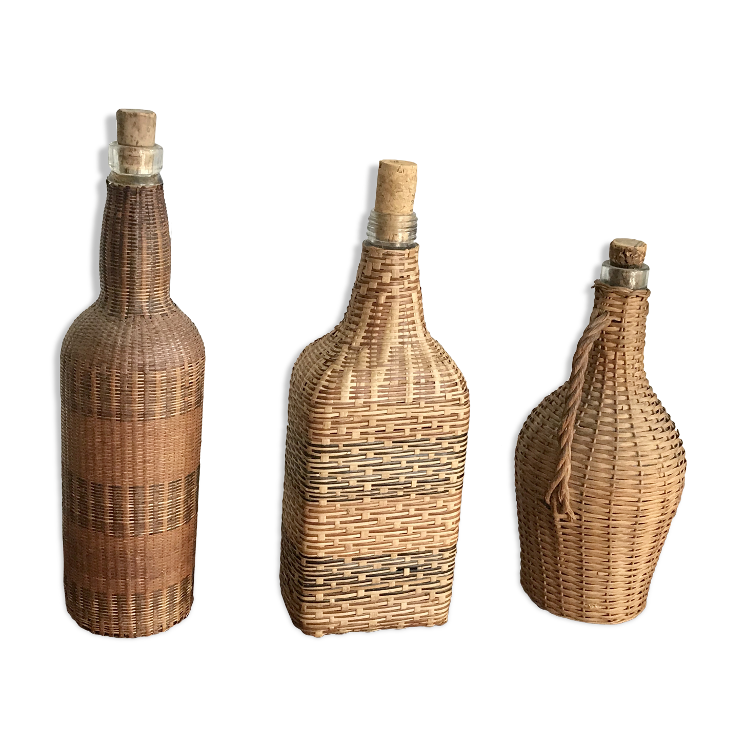 Set of three vintage rattan bottles