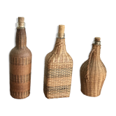 Set of three vintage rattan bottles