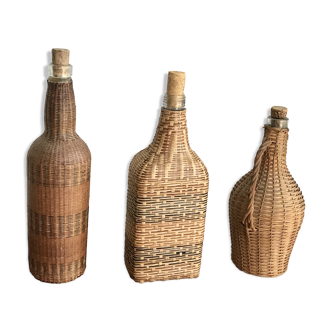 Set of three vintage rattan bottles