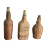 Set of three vintage rattan bottles