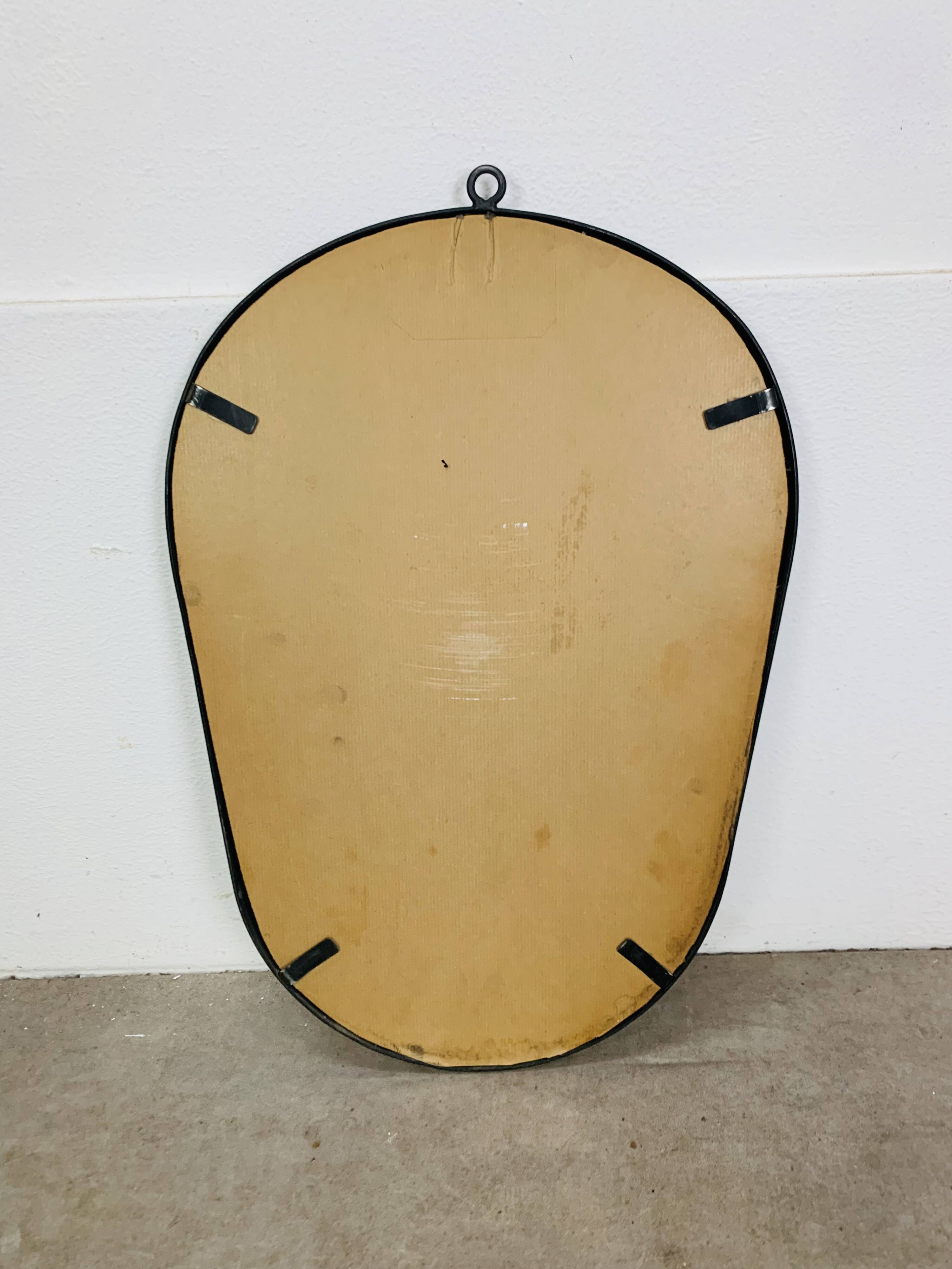Oval mirror from the 1950s, wrought iron and brass.