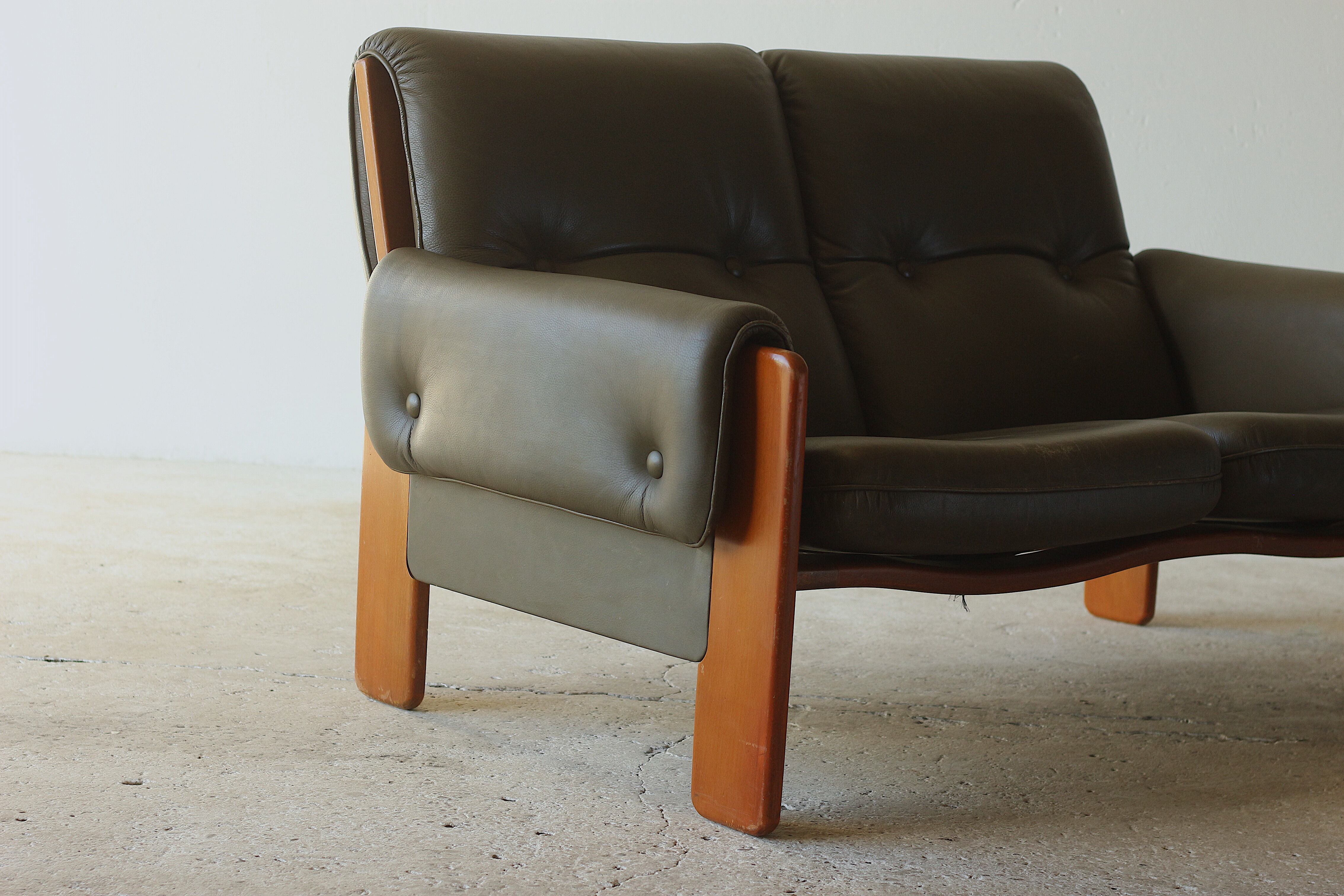Olive leather two seater sofa, 1970'