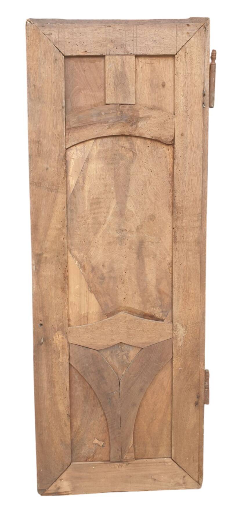 Paneled and carved wooden cupboard door