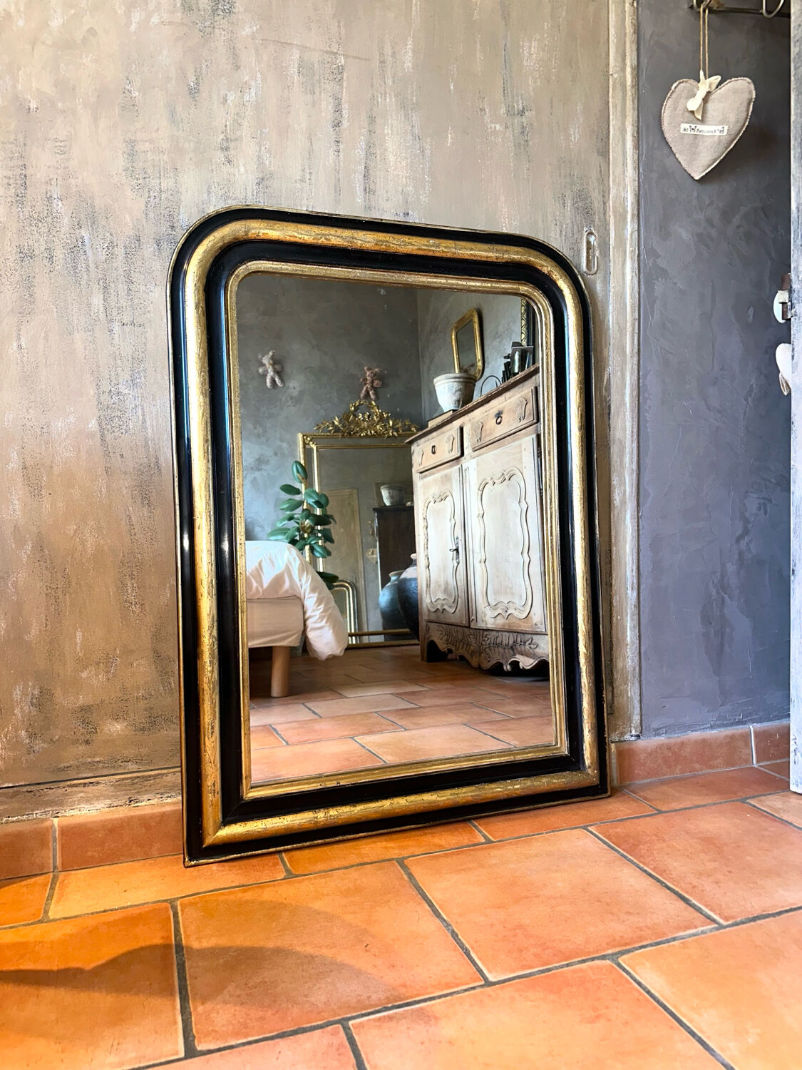 Louis-Philippe black and gold antique mirror from the 19th century