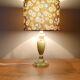 Table lamp with light green onyx base, fabric shade with a khaki background.