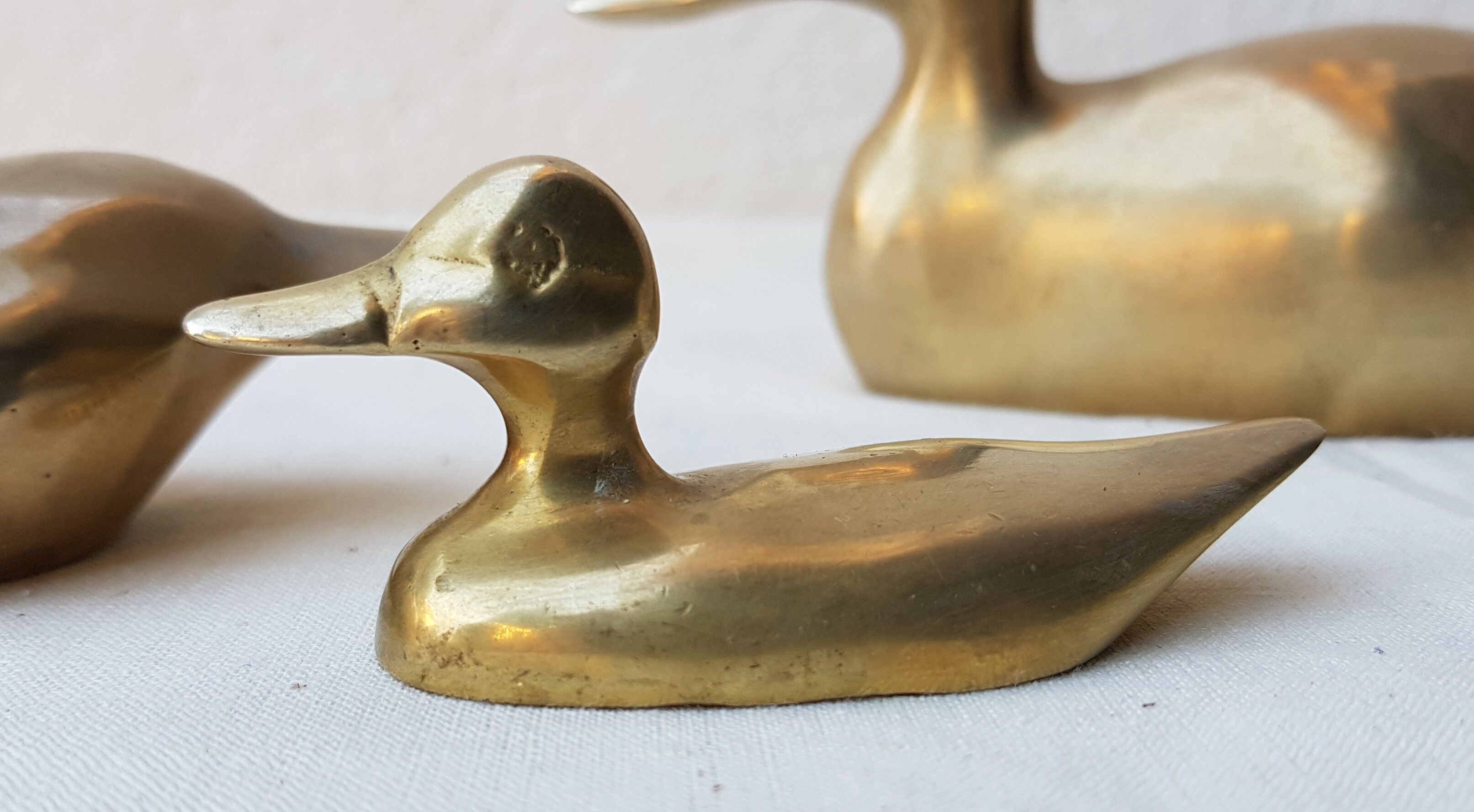 Trio of brass ducks