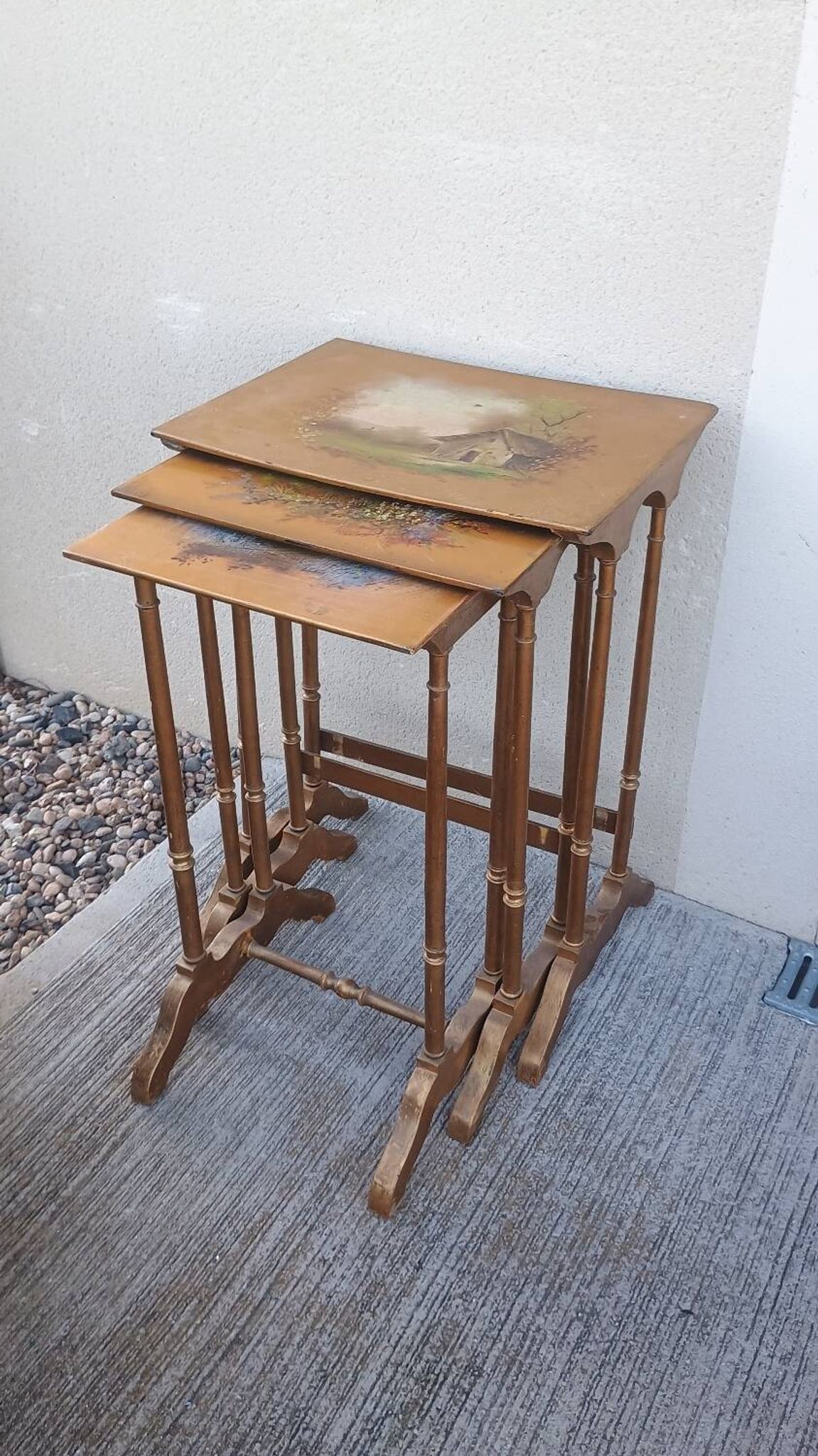 Sets of three nesting tables with painted landscape decorations in poplar.