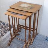 Sets of three nesting tables with painted landscape decorations in poplar.
