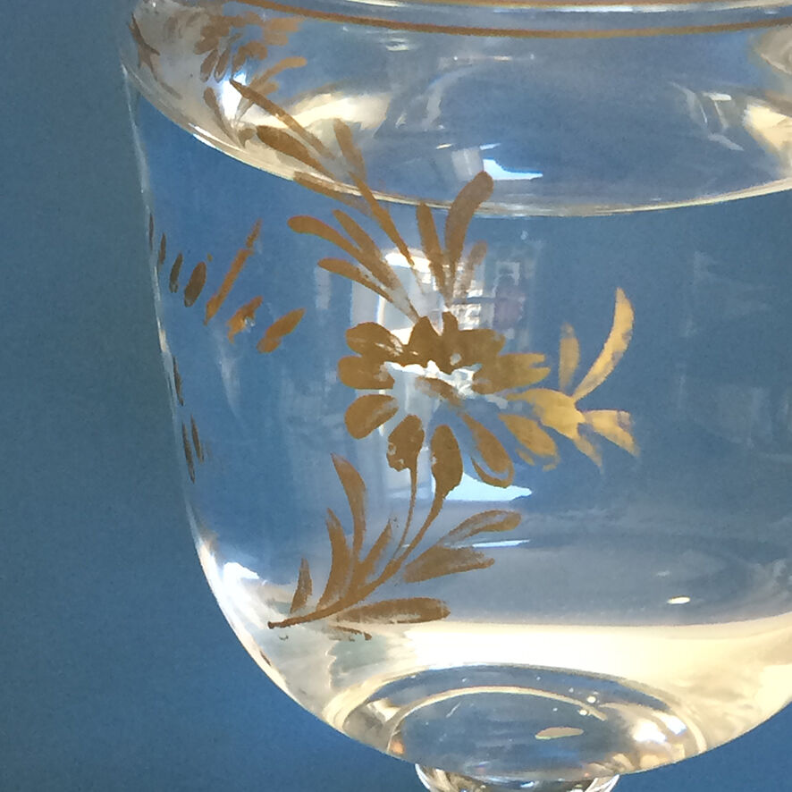 Two antique walking glasses with gold-painted floral decoration