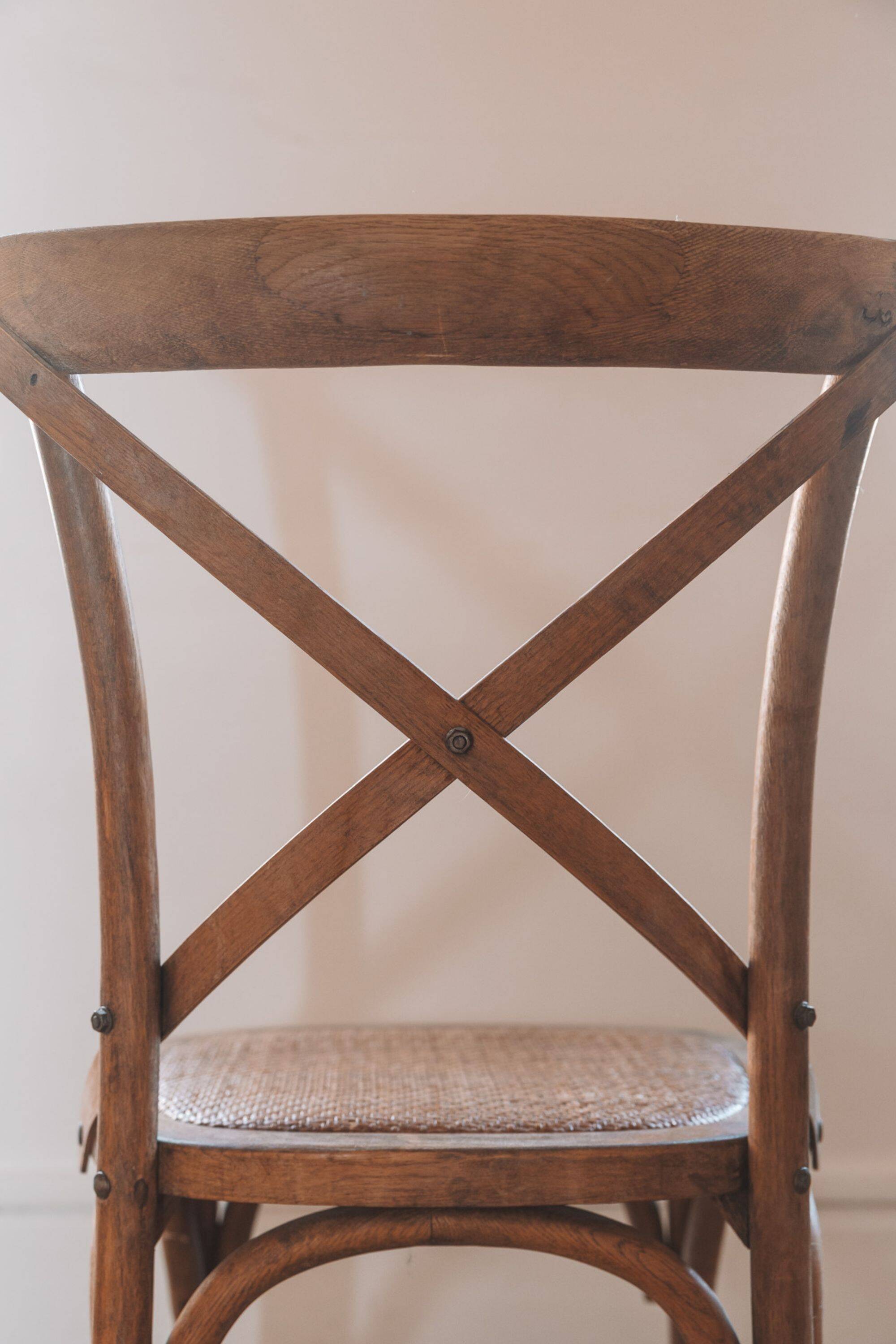 Bistro chairs with cross-back, cane seat.