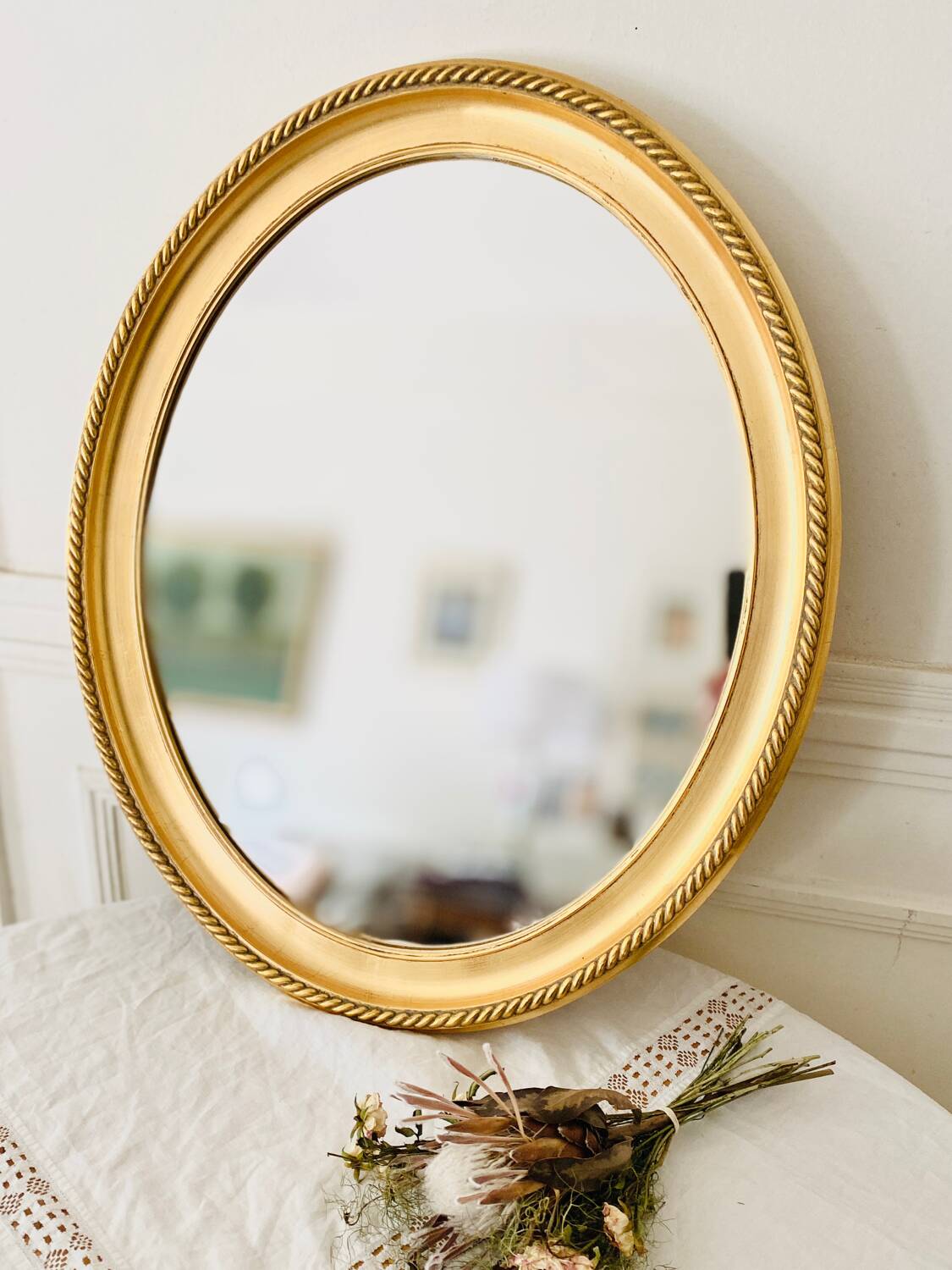 Oval wall mirror in gilded wood